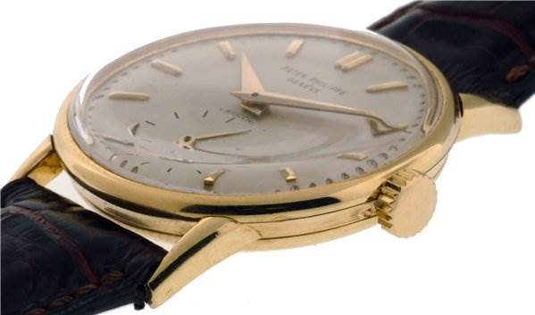 The image shows a side angle of the Vintage Patek Philippe watch, displaying the crown, case, dial, and leather strap.