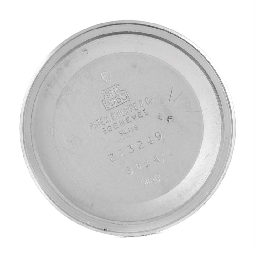 This image shows the inside case back cover of a vintage Patek Philippe watch, displaying model and serial numbers.