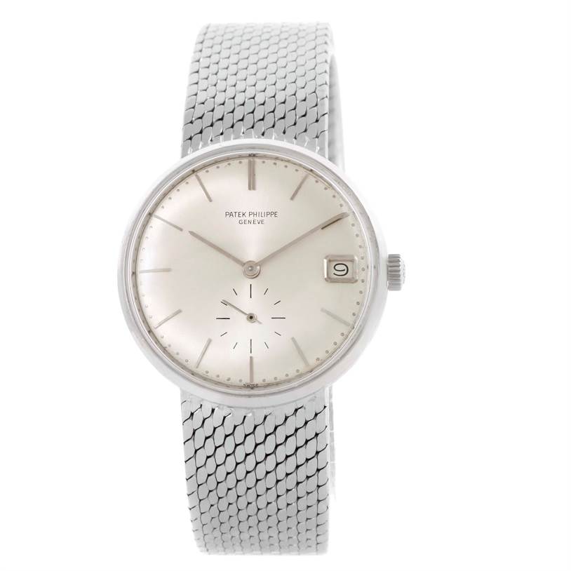 This image shows a frontal view of a Vintage Patek Philippe watch, featuring the dial, date window, and metal mesh band.