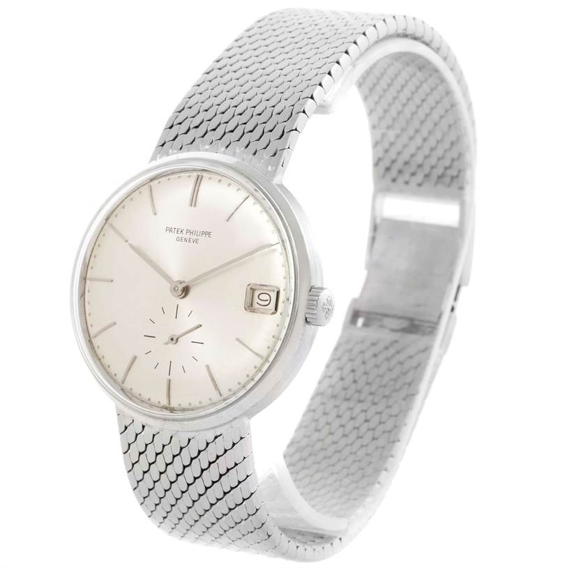 This image shows a Vintage Patek Philippe watch from a side angle, highlighting its face and metal mesh strap.