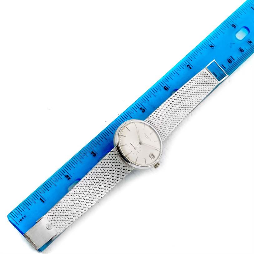 The image shows a Patek Philippe Vintage watch, with its bracelet fully extended adjacent to a blue ruler for scale.