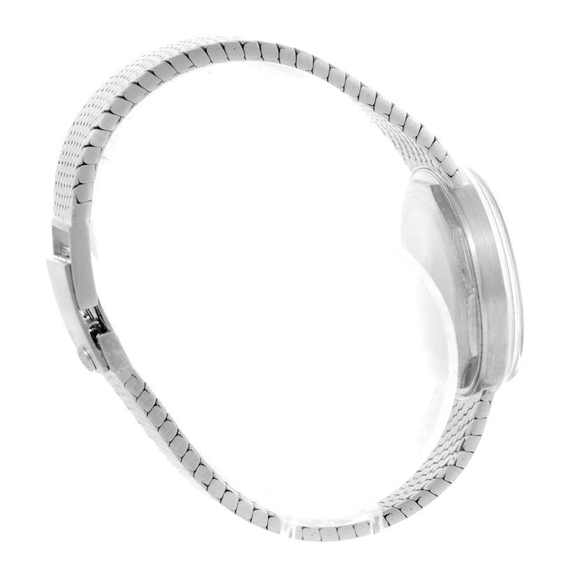 This image shows the side view of a Vintage Patek Philippe watch, highlighting the metallic strap and the watch case.