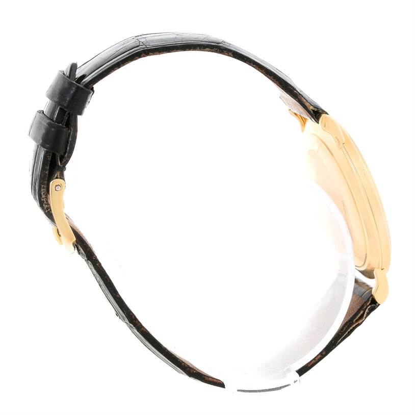 The image shows a side profile of a Patek Philippe Calatrava 3919 Men's Yellow Gold White Dial 3919 Men's Yellow Gold White Dial watch, highlighting its strap, buckle, and watch case.