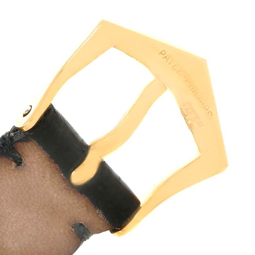 This image shows a close-up of a gold buckle with "Patek Philippe" engraving from the Calatrava model by Patek Philippe.