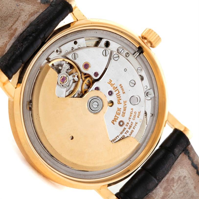The image shows the back view of the Patek Philippe Calatrava 3802 Men's Yellow Gold White Dial 3802 Men's Yellow Gold White Dial watch, revealing the intricate movement and inner mechanisms.