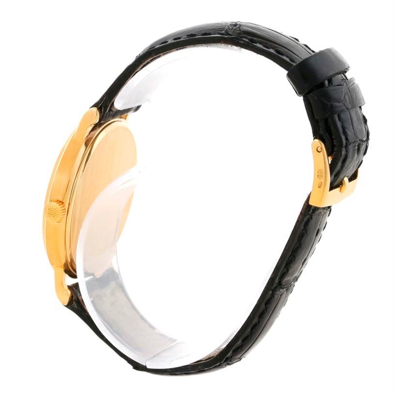 This side-angle shows the gold case, crown, and black leather strap of the Patek Philippe Calatrava 3802 Men's Yellow Gold White Dial 3802 Men's Yellow Gold White Dial watch.