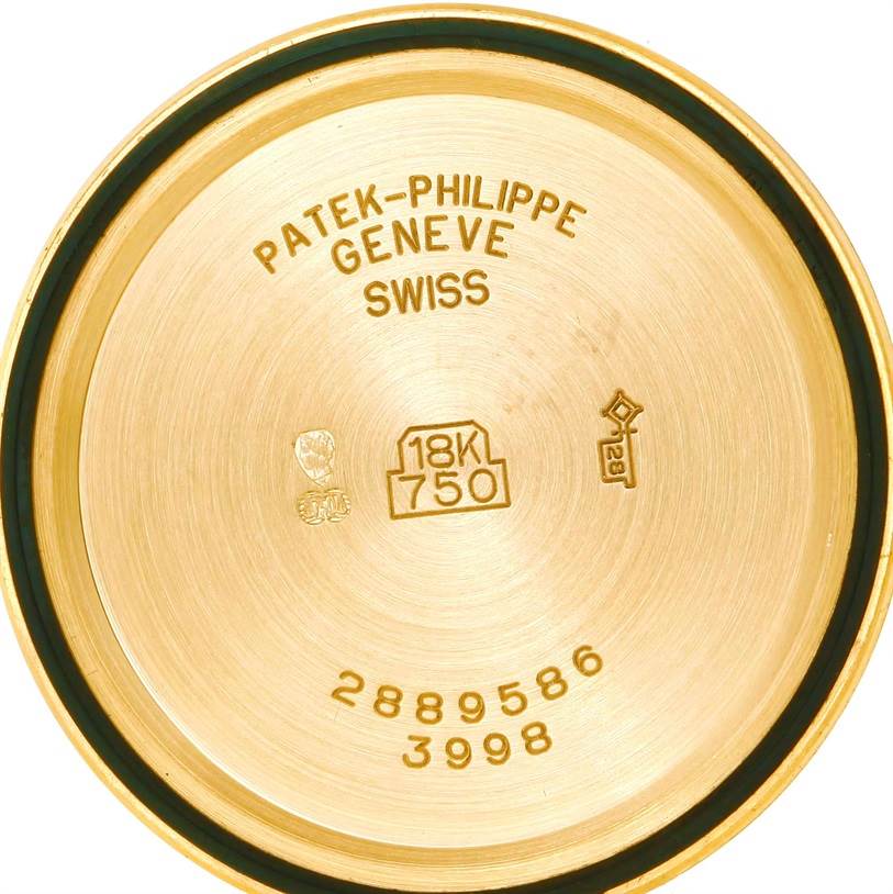 This is a back view of the case of a Patek Philippe Calatrava 3998 Men's Yellow Gold Silver Dial 3998 Men's Yellow Gold Silver Dial watch, showing the engravings and hallmarks.