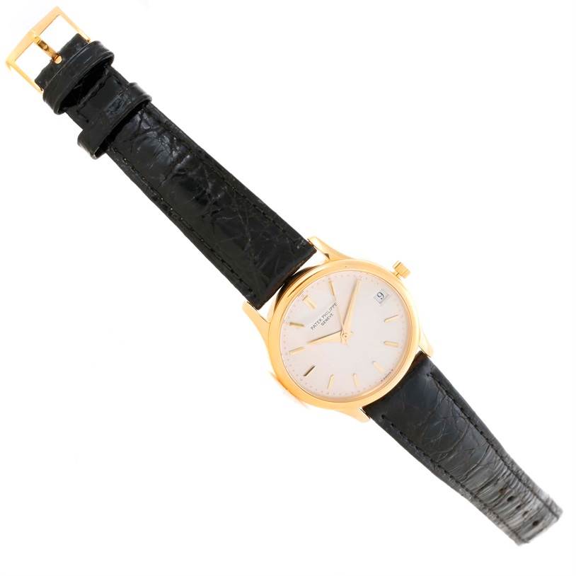 The image shows a Patek Philippe Calatrava 3998 Men's Yellow Gold Silver Dial 3998 Men's Yellow Gold Silver Dial watch with a black leather strap and a gold case, positioned at a slight diagonal angle.