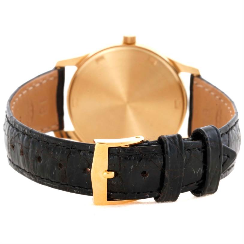 The image shows the back view of a Patek Philippe Calatrava 3998 Men's Yellow Gold Silver Dial 3998 Men's Yellow Gold Silver Dial watch, focusing on its gold buckle and black leather strap.