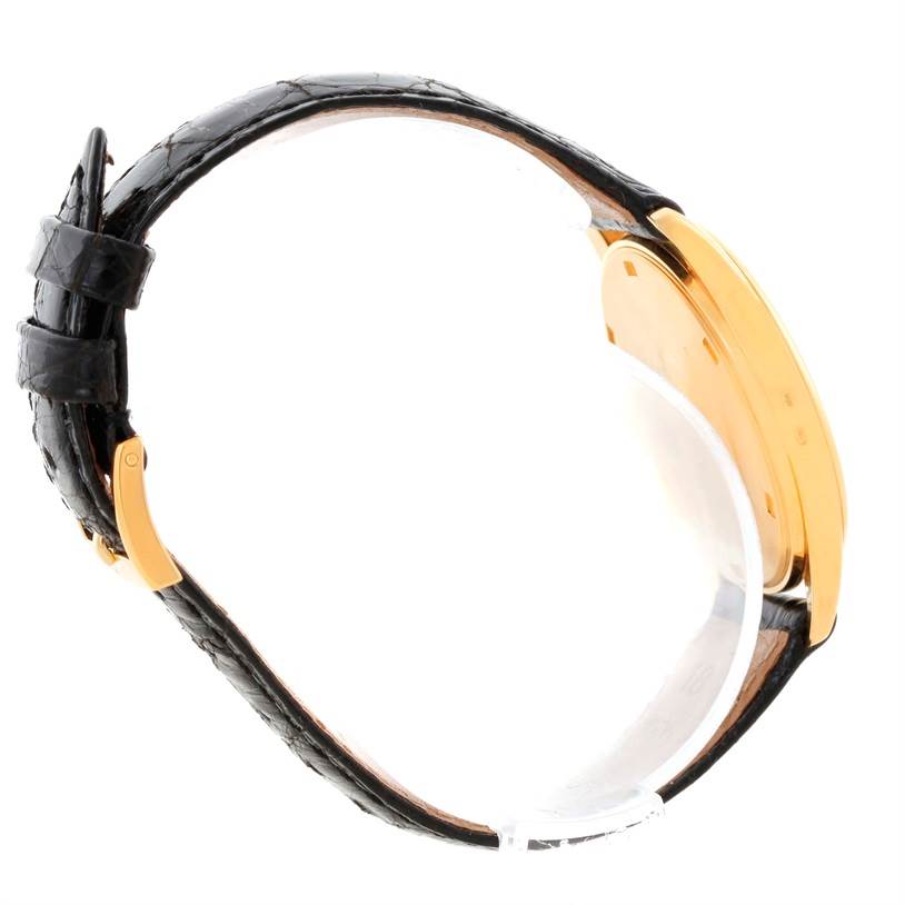 The image shows a side view of the Patek Philippe Calatrava 3998 Men's Yellow Gold Silver Dial 3998 Men's Yellow Gold Silver Dial watch, highlighting its black leather strap and gold case.