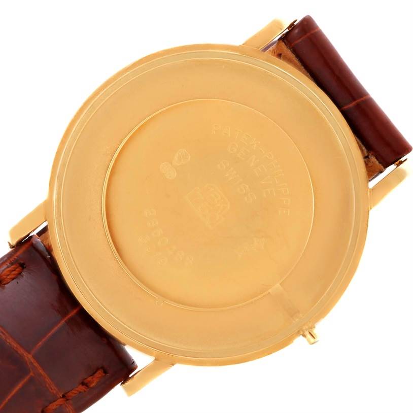 The image shows the back case of a Patek Philippe Calatrava 3919 Men's Yellow Gold White Dial 3919 Men's Yellow Gold White Dial watch with a brown leather strap.