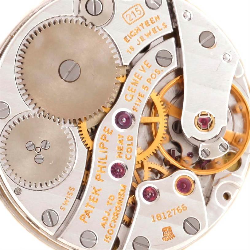 This close-up image shows the movement and intricate mechanics of the Patek Philippe Calatrava 3919 Men's Yellow Gold White Dial 3919 Men's Yellow Gold White Dial watch model.