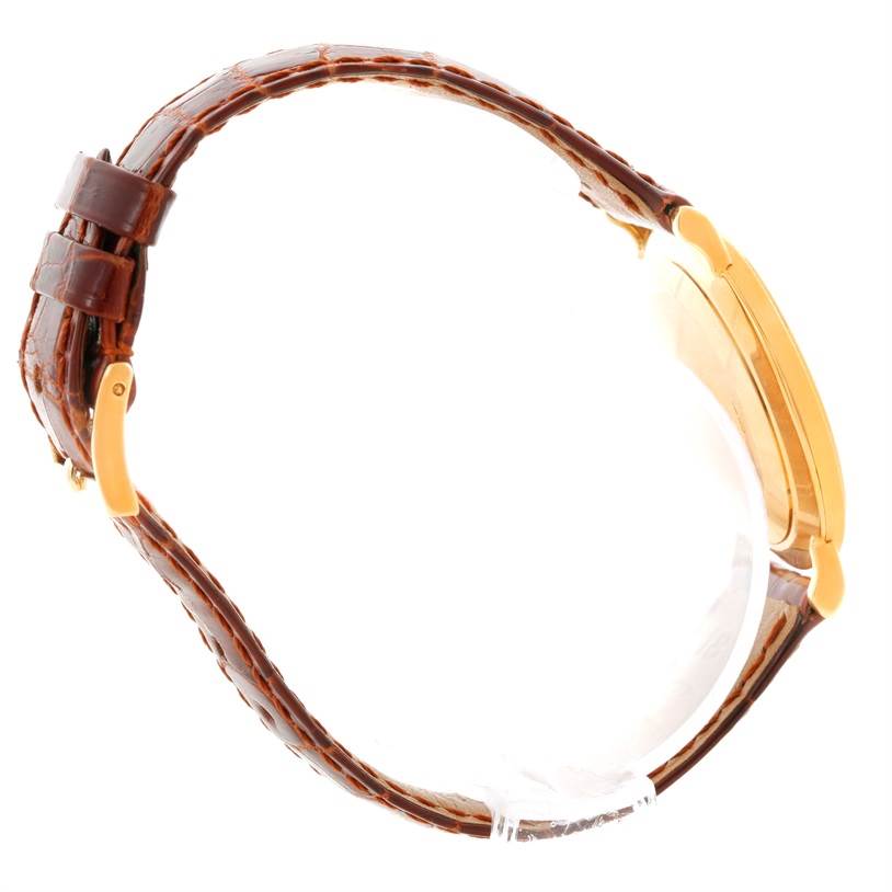 This image shows a side angle of the Patek Philippe Calatrava 3919 Men's Yellow Gold White Dial 3919 Men's Yellow Gold White Dial watch, displaying its brown leather strap and gold case.