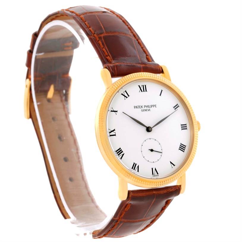 The image shows a Patek Philippe Calatrava 3919 Men's Yellow Gold White Dial 3919 Men's Yellow Gold White Dial watch at a side angle, highlighting its white dial, gold case, and brown leather strap.