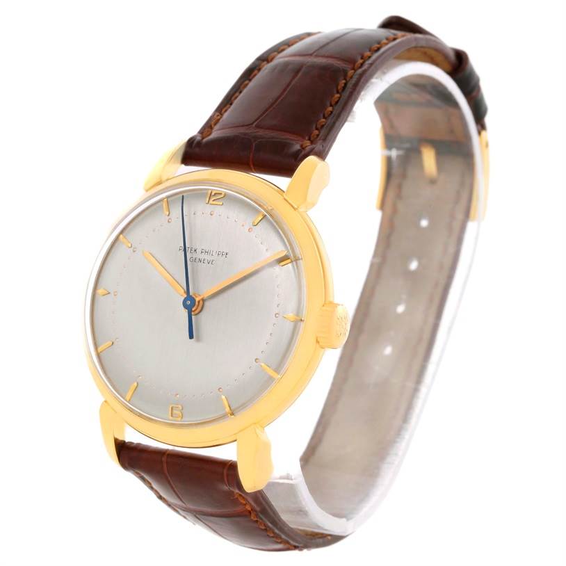 The image shows a Patek Philippe 2482 Yellow Gold Silver Dial 2482 Yellow Gold Silver Dial Calatrava 18k Yellow Gold 2482 watch with a brown leather strap, captured from an angle showcasing the dial and crown.