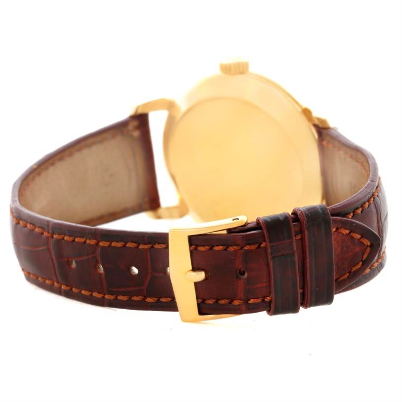 This image shows the back and side view of the Patek Philippe 2482 Yellow Gold Silver Dial 2482 Yellow Gold Silver Dial Calatrava 18k Yellow Gold Men
s Vintage Watch 2482 model, focusing on the clasp and band.