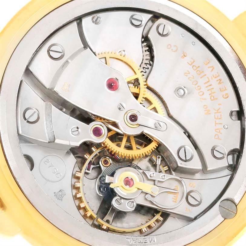 The image shows the back view of the Patek Philippe 2482 Yellow Gold Silver Dial 2482 Yellow Gold Silver Dial Calatrava 18k Yellow Gold Men
s Vintage Watch, Model 2482, revealing its intricate internal mechanisms.