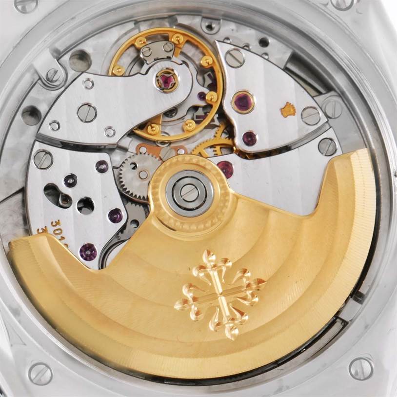 This is a close-up of the movement of a Patek Philippe Sculpture 5091/1A-001 Women's Stainless Steel White Dial 5091/1A-001 Women's Stainless Steel White Dial watch, showing gears and the gold rotor.