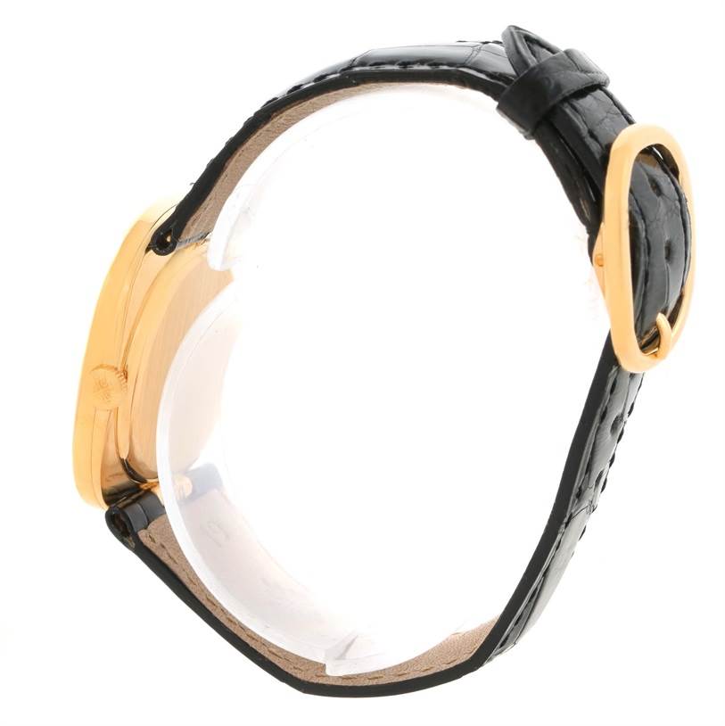 The image shows the side view of the Patek Philippe Golden Ellipse 3948 Men's Yellow Gold White Dial 3948 Men's Yellow Gold White Dial watch, featuring its case, crown, and leather strap with a buckle.