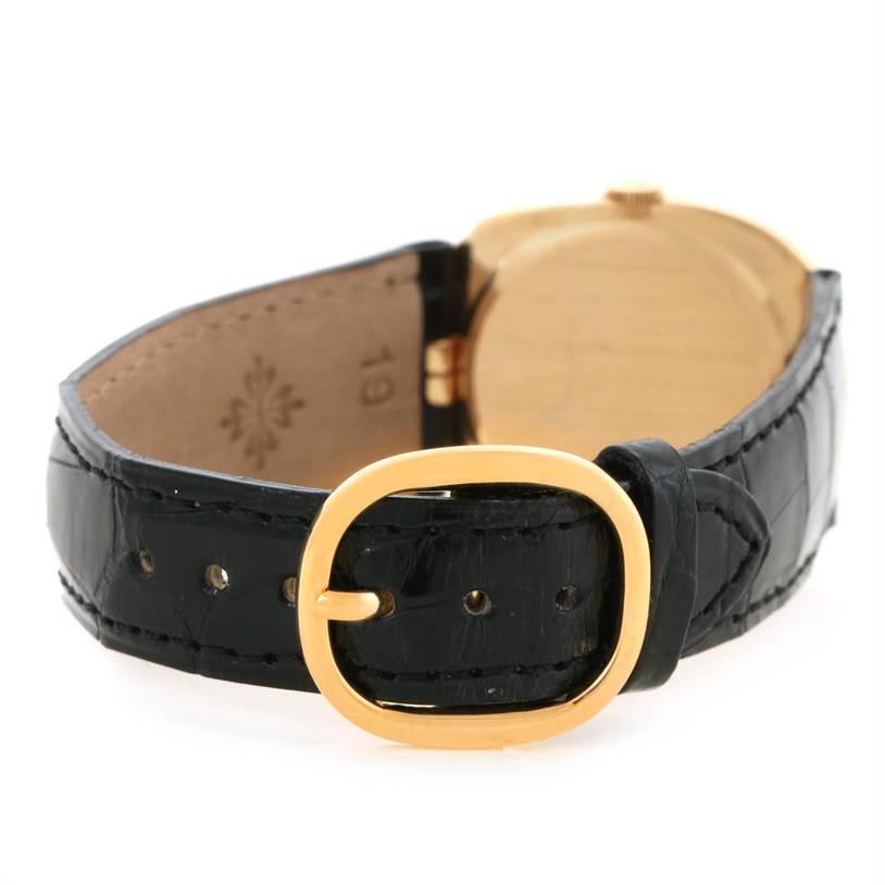 This image shows a rear view of the Patek Philippe Golden Ellipse 3948 Men's Yellow Gold White Dial 3948 Men's Yellow Gold White Dial watch, focusing on the black leather strap and gold buckle.