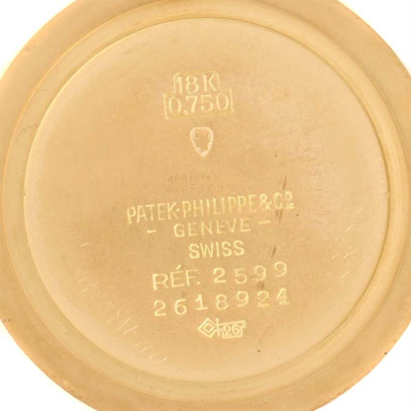 This image shows the inside case back of a Vintage Patek Philippe model 2599 wristwatch, detailing its reference number and gold purity.
