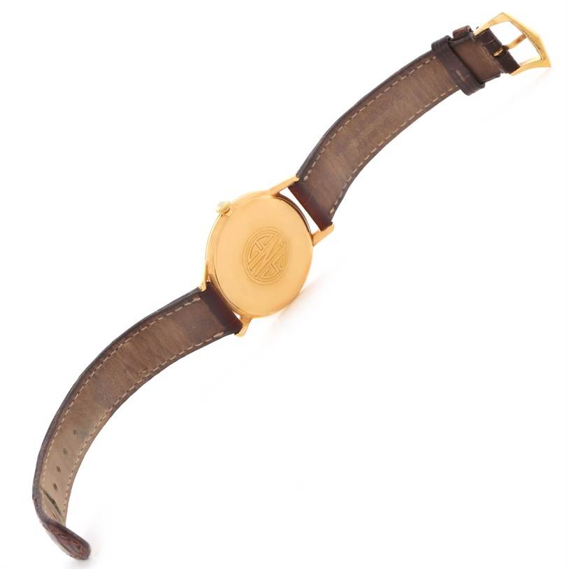 The image shows the back case and leather strap of a Vintage Patek Philippe watch from a top-down angle.