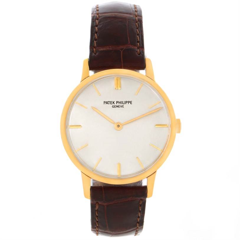 The image shows a front view of a Vintage Patek Philippe watch featuring a gold case and brown leather strap.