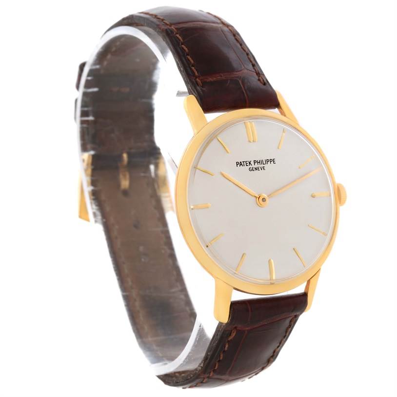 The image shows a Vintage Patek Philippe watch angled from the front-left, featuring the dial, case, crown, and leather strap.