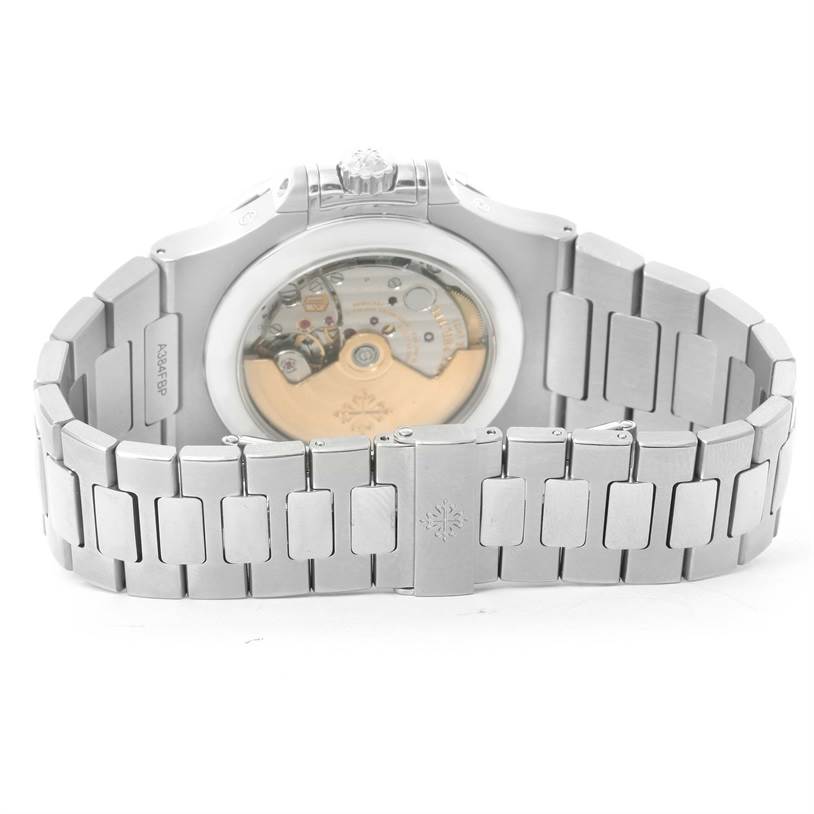 The image shows the back side of the Patek Philippe Nautilus 5726/1A-010 Men's Stainless Steel White Dial 5726/1A-010 Men's Stainless Steel White Dial watch, highlighting its movement and metal bracelet.