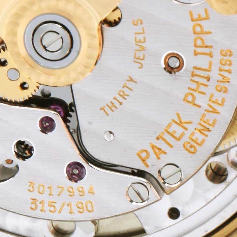 This image shows the movement and internal mechanics of a Patek Philippe Calatrava 3802 Men's Yellow Gold White Dial 3802 Men's Yellow Gold White Dial watch at a close-up angle.