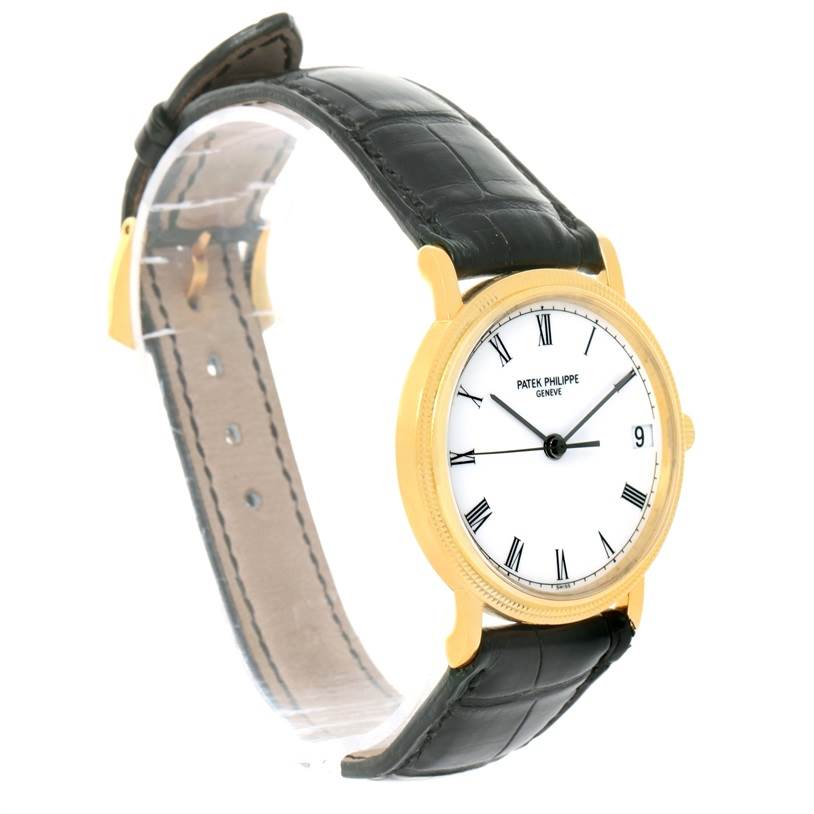 The image shows a side angle of the Patek Philippe Calatrava 3802 Men's Yellow Gold White Dial 3802 Men's Yellow Gold White Dial watch, highlighting its black leather strap and gold case.