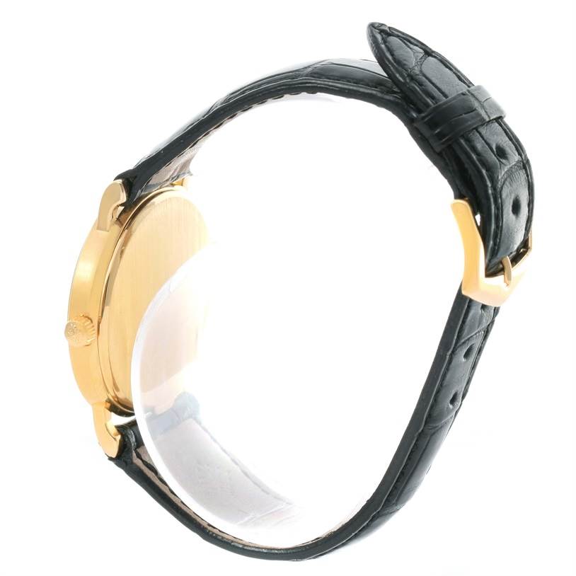 This image shows a side view of a Patek Philippe Calatrava 3802 Men's Yellow Gold White Dial 3802 Men's Yellow Gold White Dial watch, highlighting its case, crown, and leather strap.