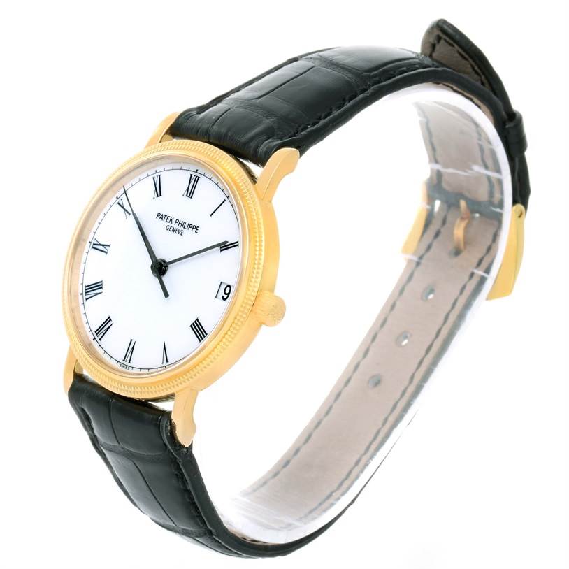 The Patek Philippe Calatrava 3802 Men's Yellow Gold White Dial 3802 Men's Yellow Gold White Dial watch is shown at an angled view, displaying its face, case, strap, and buckle.