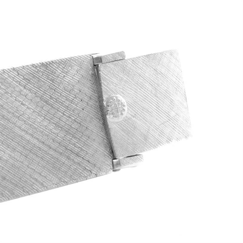 This image shows the clasp and part of the bracelet of a vintage Patek Philippe watch, highlighting its textured design.