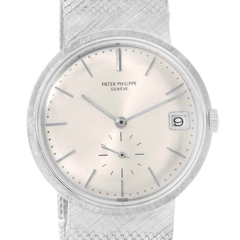 The image shows a front view of a Vintage Patek Philippe watch, highlighting its dial, hands, date window, and crown.