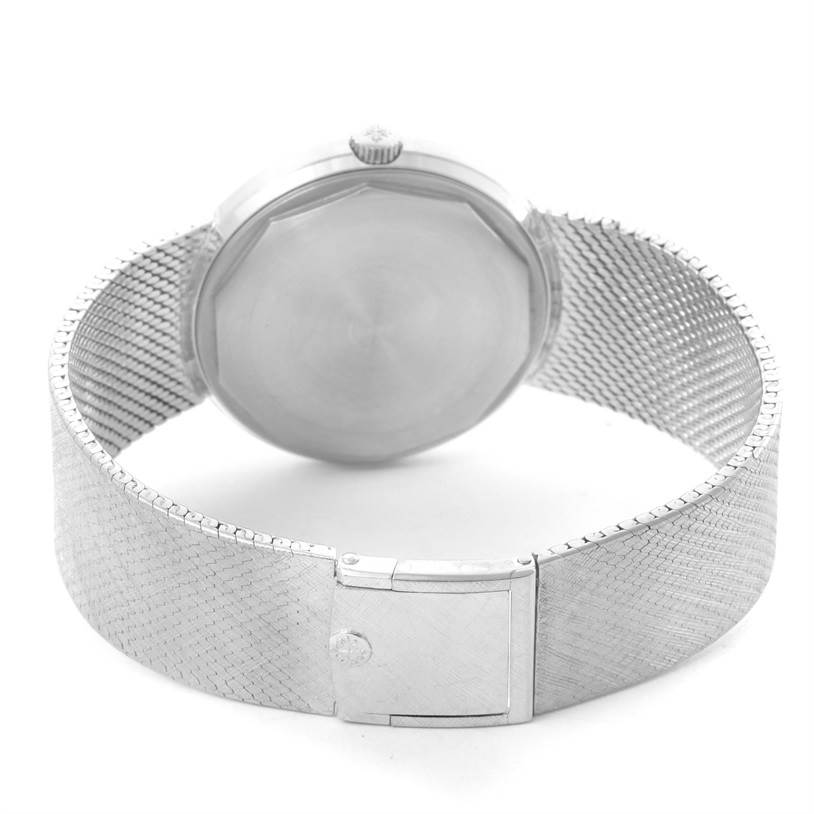 The image shows the back case and mesh strap of a vintage Patek Philippe watch, viewed from the rear.