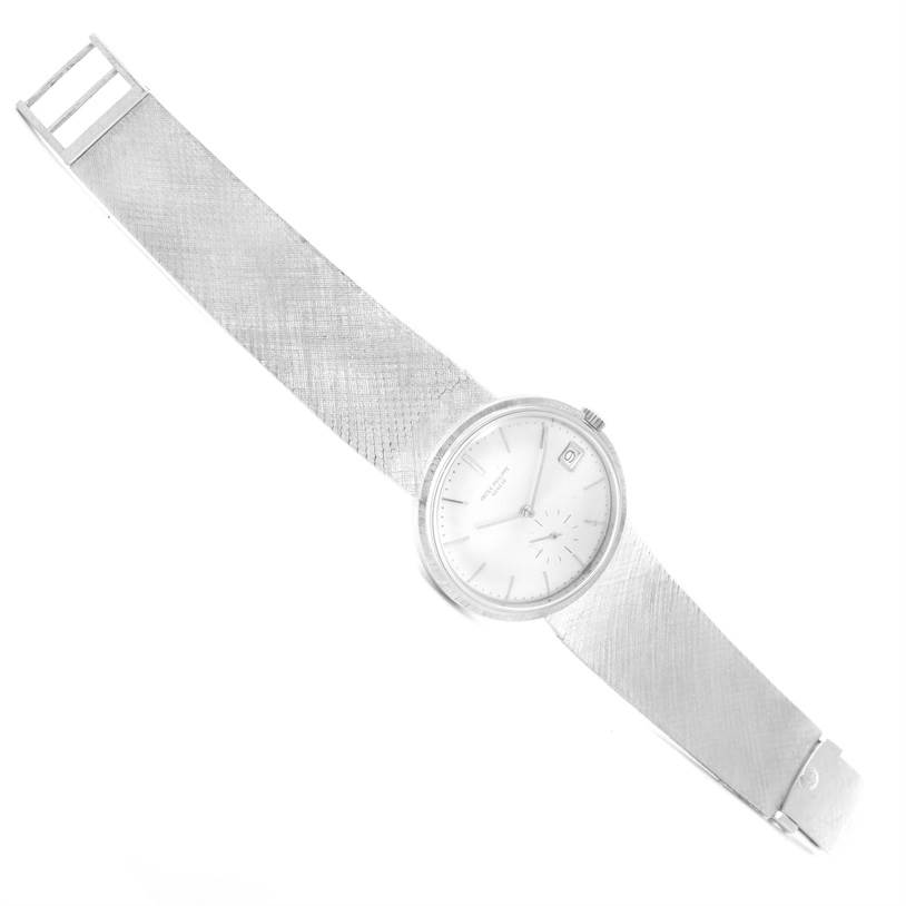 The image shows a top-down view of a Vintage Patek Philippe watch, showcasing the dial, bezel, crown, and full metal strap.