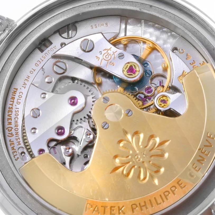 The image shows a close-up of the movement and internal mechanics of a vintage Patek Philippe watch.
