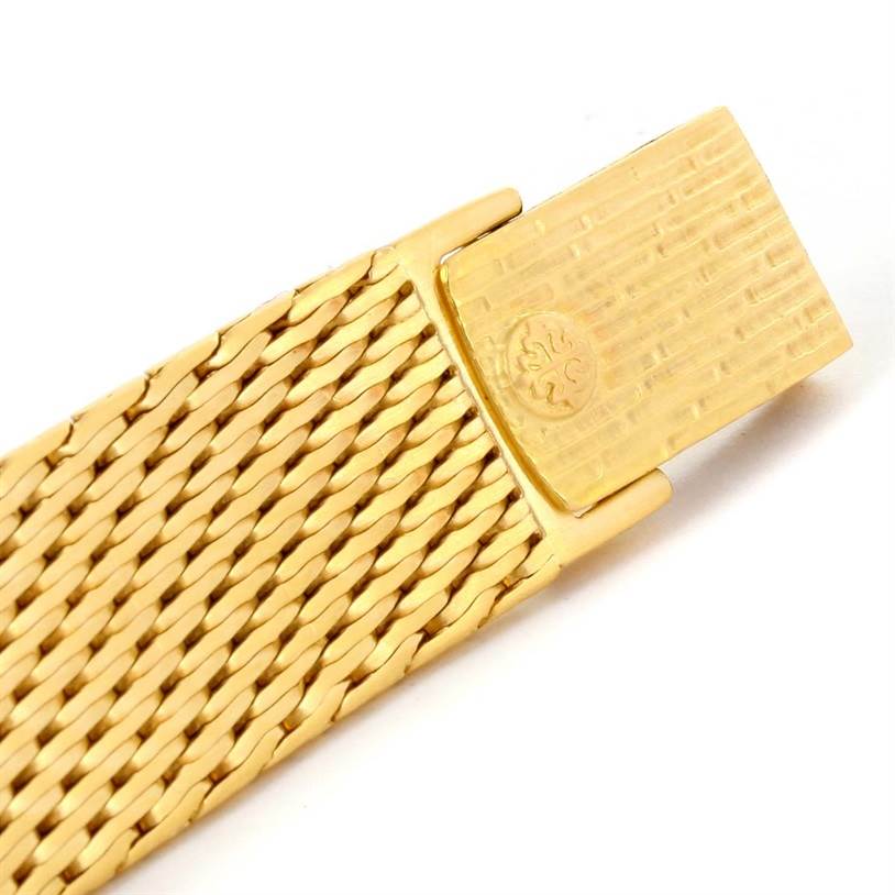 This image shows the clasp of a Patek Philippe Golden Ellipse 3748 Men's Yellow Gold Blue Dial 3748 Men's Yellow Gold Blue Dial watch bracelet, featuring a woven design.