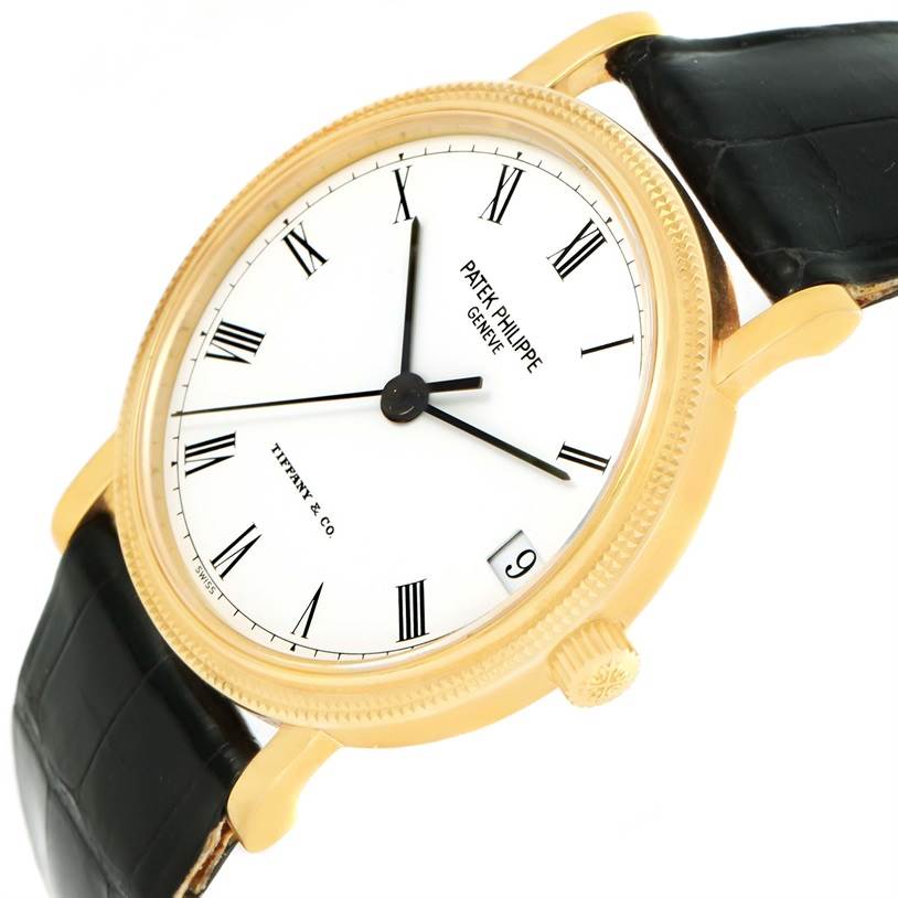 This image shows a Patek Philippe Calatrava 3802 Men's Yellow Gold White Dial 3802 Men's Yellow Gold White Dial watch at a slight angle, highlighting its face, bezel, crown, and leather strap.