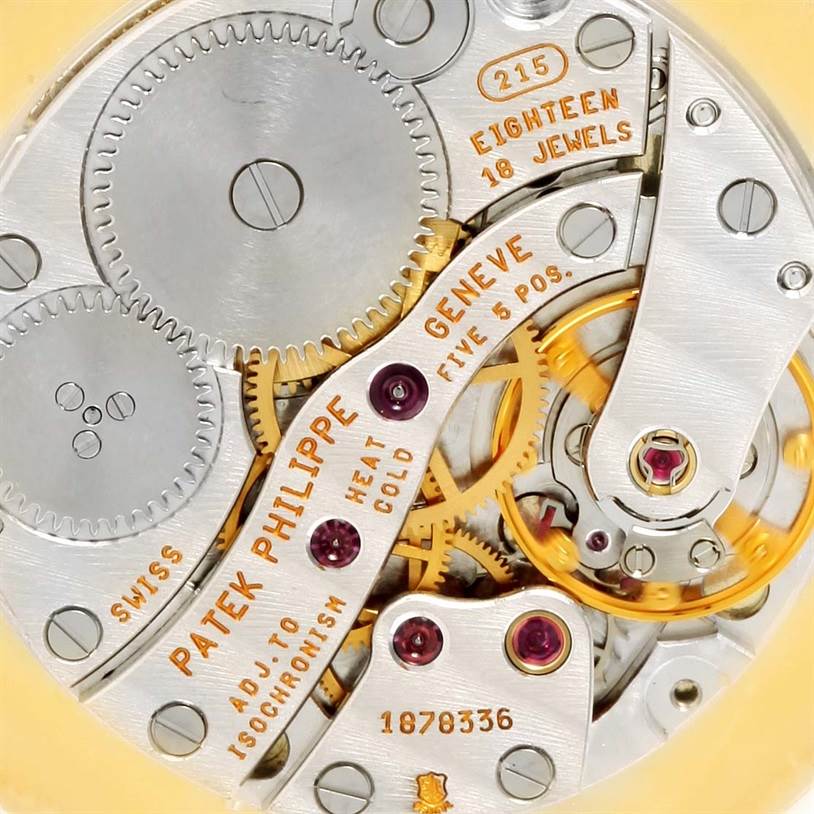 The image shows the intricate inner movement and gears of a Patek Philippe Calatrava 3919 Men's Yellow Gold White Dial 3919 Men's Yellow Gold White Dial watch from a close-up angle.