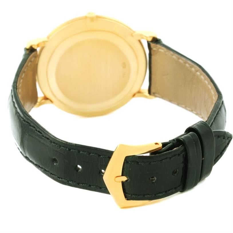 The image shows the rear view of a Patek Philippe Calatrava 3919 Men's Yellow Gold White Dial 3919 Men's Yellow Gold White Dial watch, highlighting the case back and leather strap with a gold buckle.