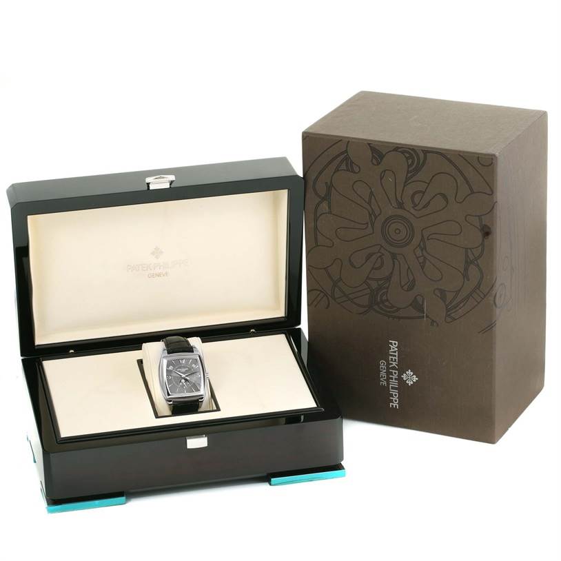 The image shows a Patek Philippe Gondolo 5135G Men's White Gold Black Dial 5135G Men's White Gold Black Dial watch in its open display box with the exterior packaging on the right.