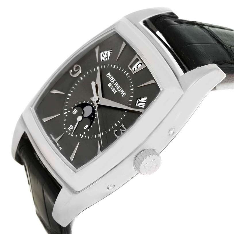 The image shows a side angle of the Patek Philippe Gondolo 5135G Men's White Gold Black Dial 5135G Men's White Gold Black Dial watch, highlighting its face, crown, and black leather strap.