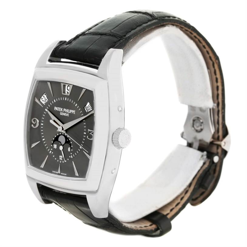 This image shows a side and front angle of the Patek Philippe Gondolo 5135G Men's White Gold Black Dial 5135G Men's White Gold Black Dial watch, highlighting its dial, crown, and strap.