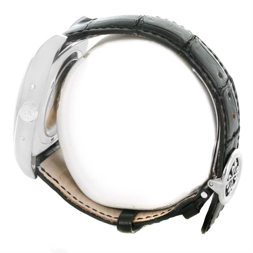 The image shows a side profile of the Patek Philippe Gondolo 5135G Men's White Gold Black Dial 5135G Men's White Gold Black Dial model, highlighting its case and black leather strap.