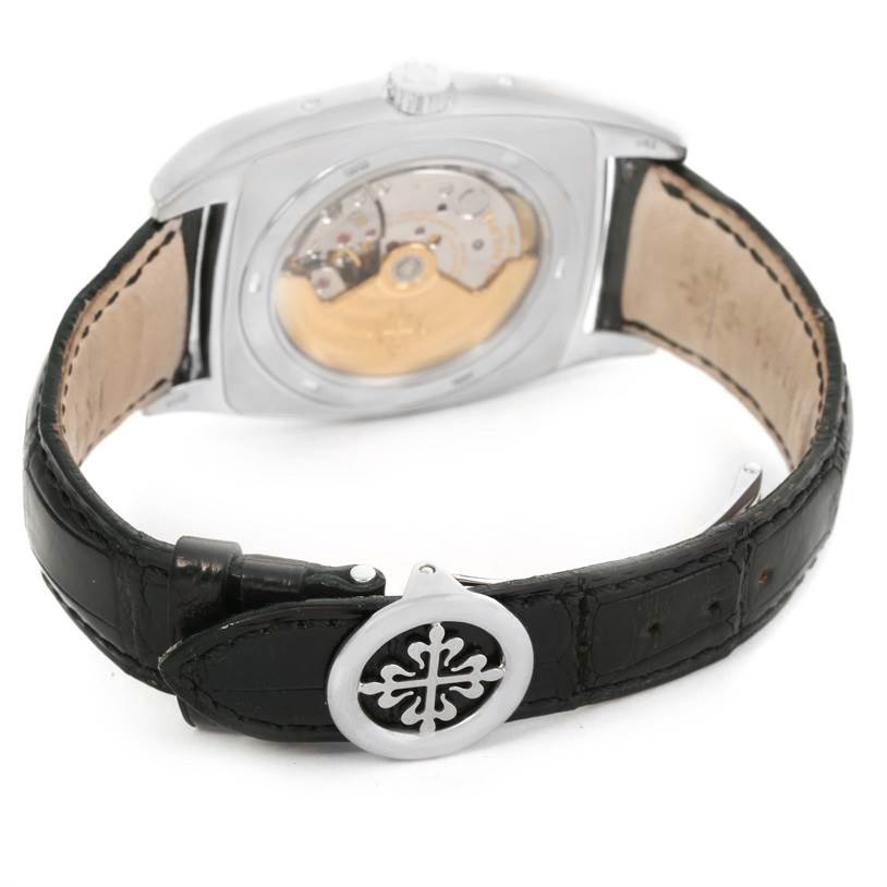 The image displays the back view of a Patek Philippe Gondolo 5135G Men's White Gold Black Dial 5135G Men's White Gold Black Dial watch, showing its movement and black leather strap.