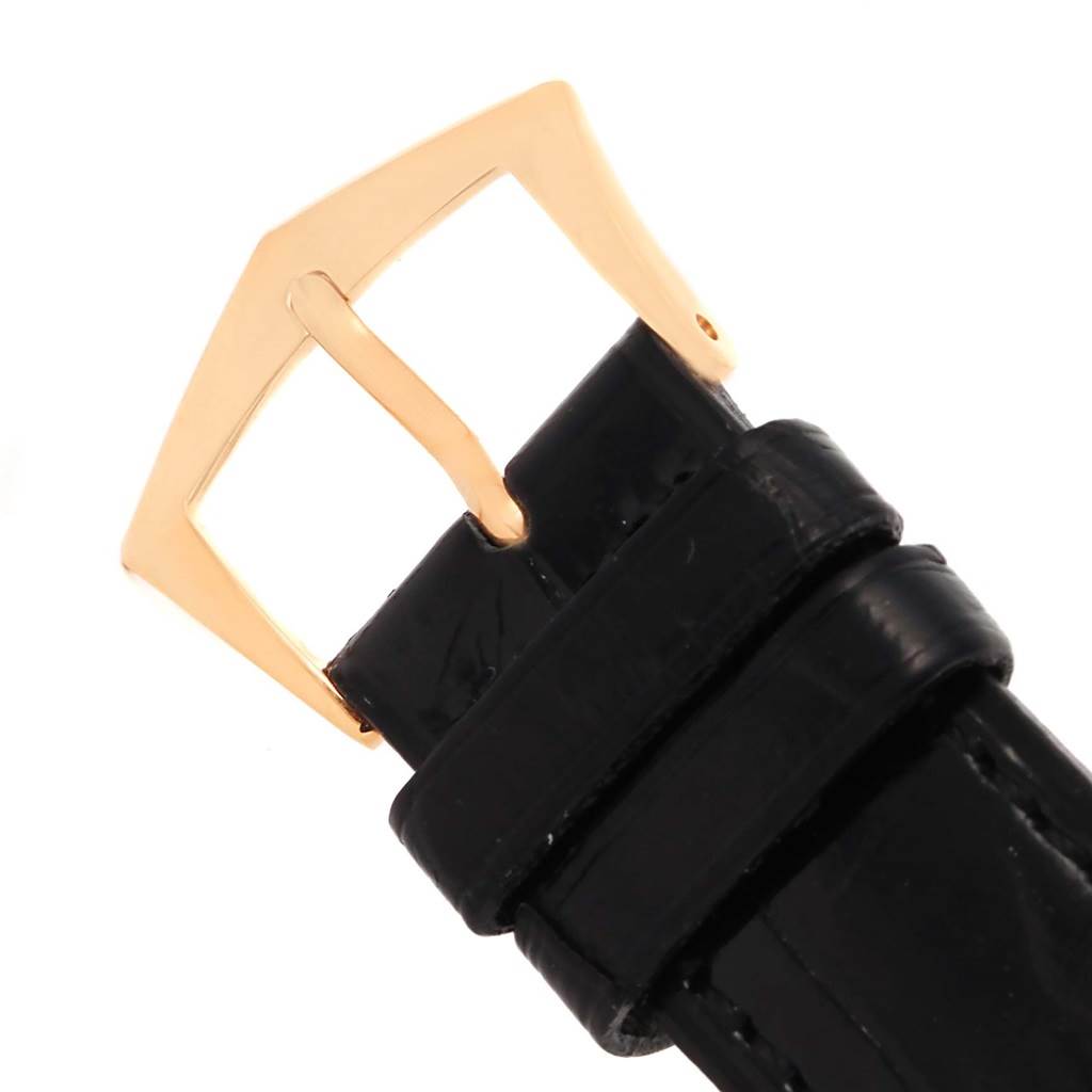 This image shows a close-up of the buckle and part of the leather strap of a Calatrava model by Patek Philippe.