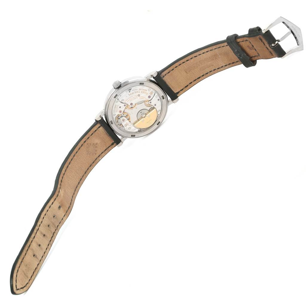 This image shows the back view of a Patek Philippe Calatrava 5120G Men's White Gold White Dial 5120G Men's White Gold White Dial watch, depicting its movement and leather strap.