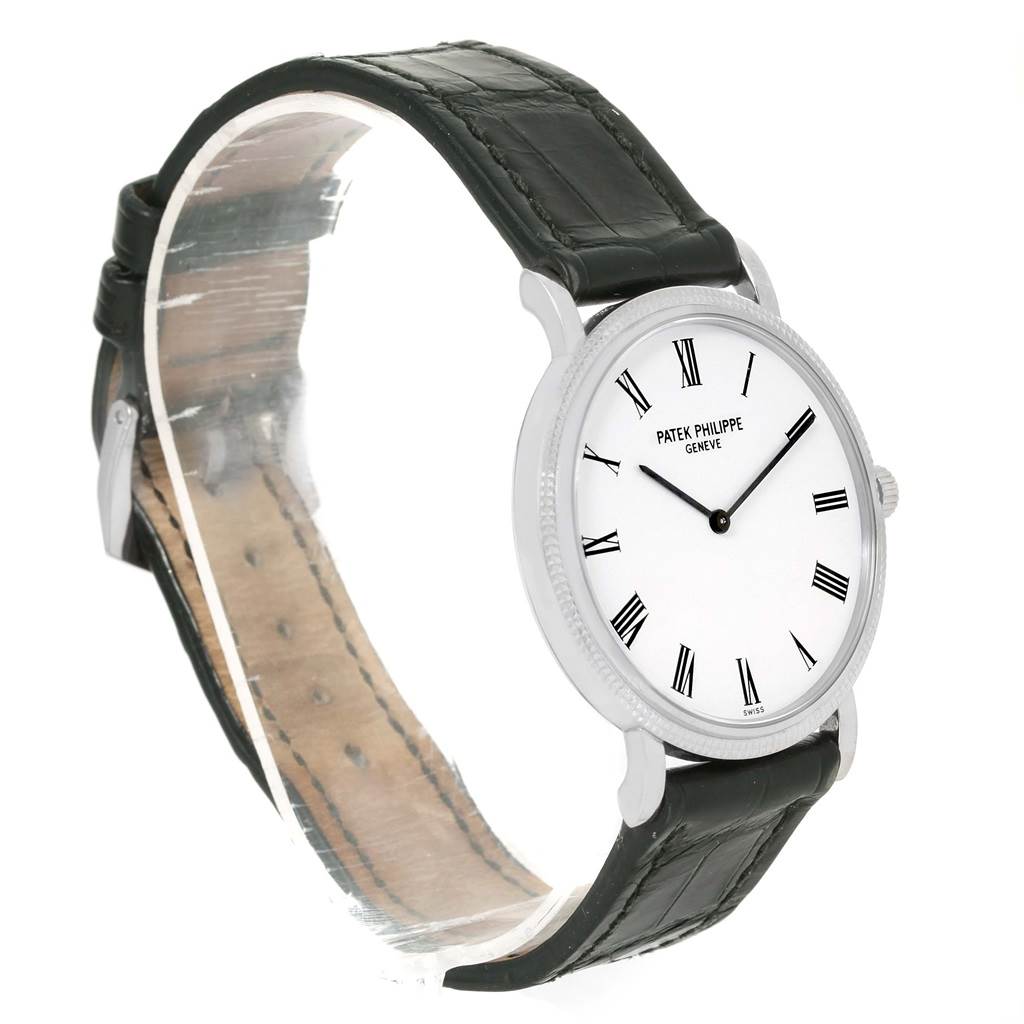 This image shows a side angle of the Patek Philippe Calatrava 5120G Men's White Gold White Dial 5120G Men's White Gold White Dial watch, highlighting its dial, bezel, and leather strap.